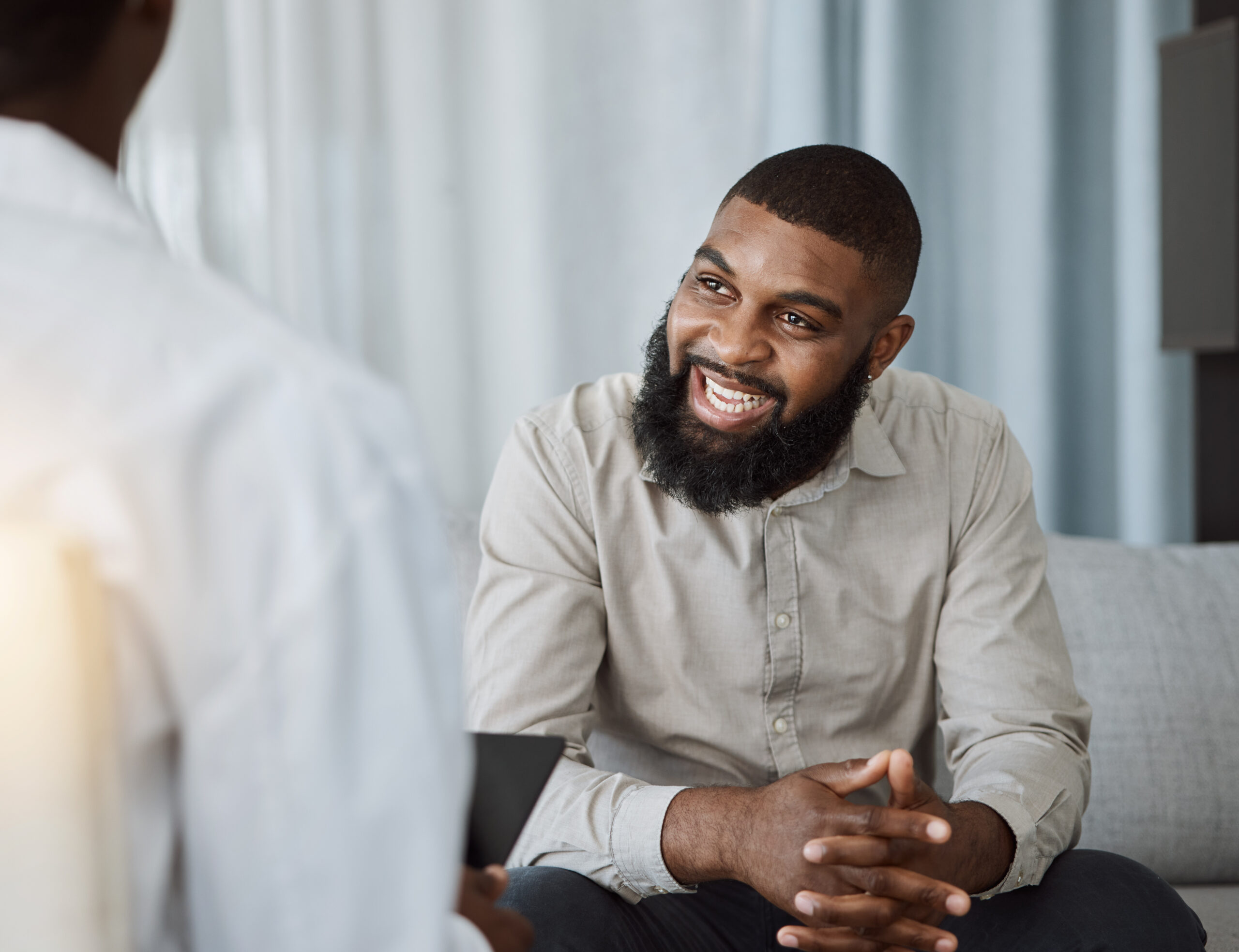 Happy black man, therapist and consultation in meeting for healthcare, mental health or therapy at the hospital. African male person talking to consultant in physiology, counseling or medical help Happy black man, therapist and consultation in meeting for healthcare, mental health or therapy at the hospital. African male person talking to consultant in physiology, counseling or medical help.